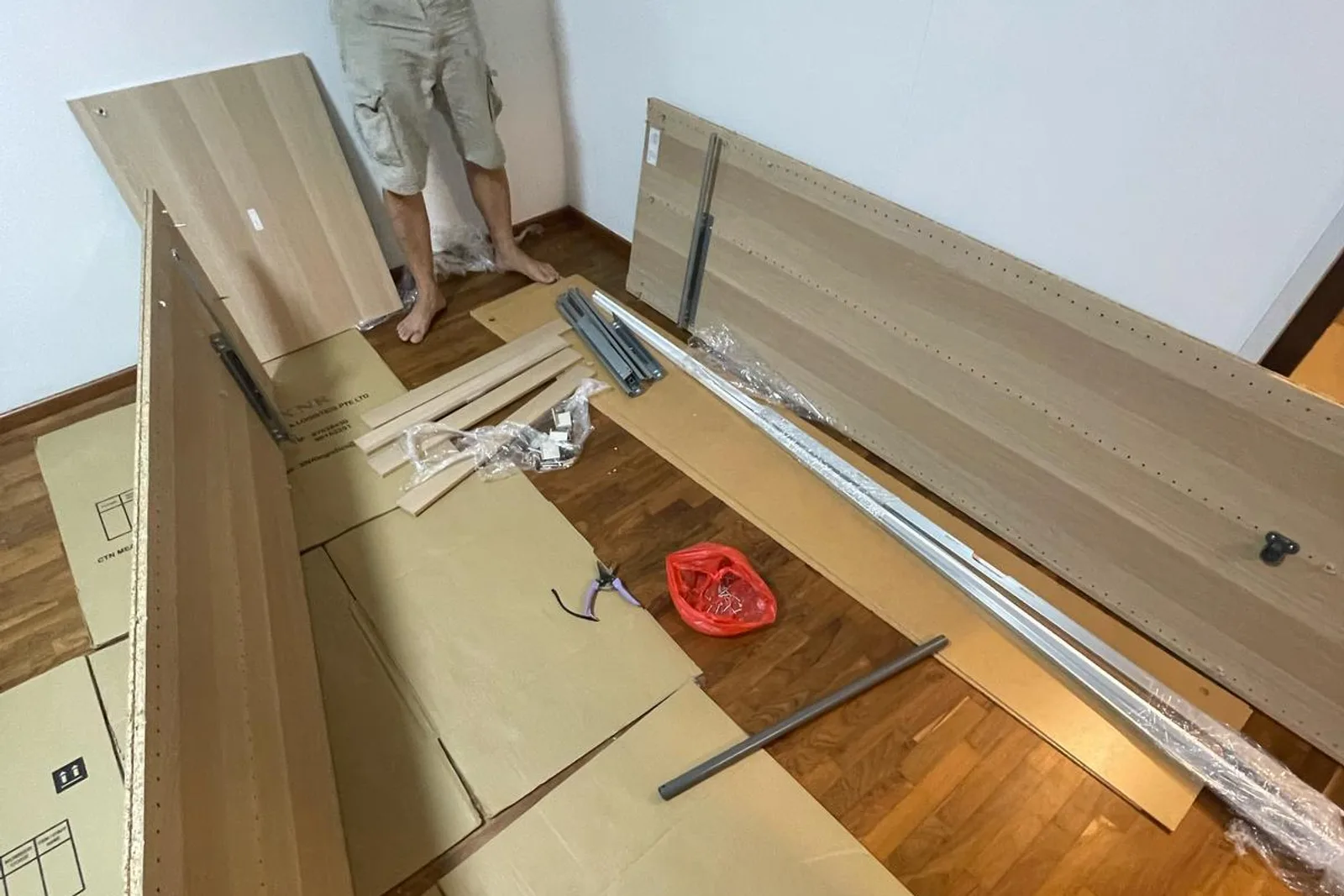Mover assembling furniture in a Singapore room