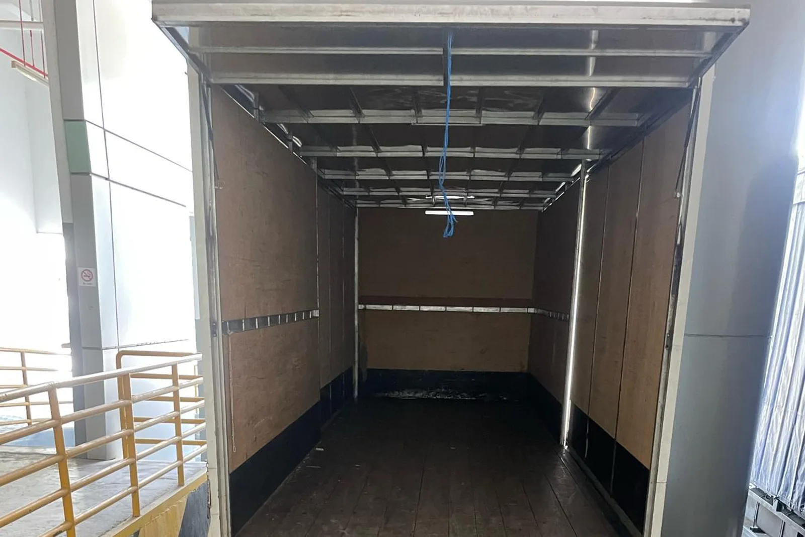 Empty box truck prepared at a Singapore loading bay
